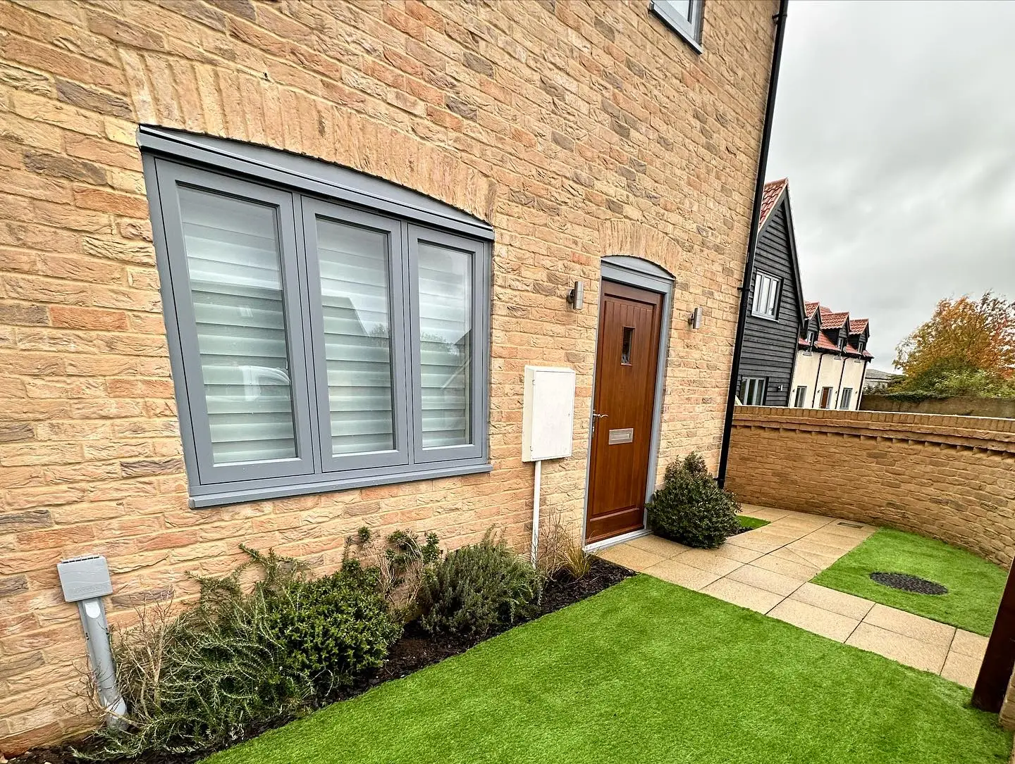 Front garden with new turf, planting and a porcelain path by JDS Landscaping