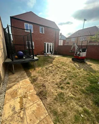 Garden during groundworks with a mini digger on site