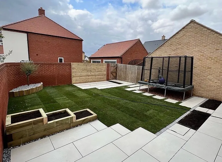 New build garden laid out with lawn, timber raised beds and porcelain steps by JDS Landscaping