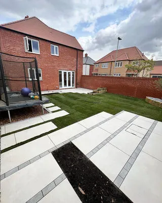 Porcelain stepping stones across a new lawn